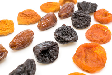 dried fruits, apples, plums, apricots, figs on a white