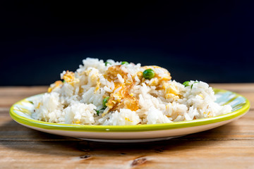 Homemade Chinese fried rice with vegetables and fried eggs