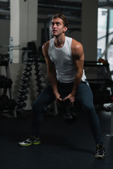 Fototapeta na wymiar Handsome, fit man working out in the gym