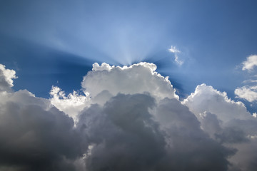 Blue sky with puffy white clouds in bright clear sunny day