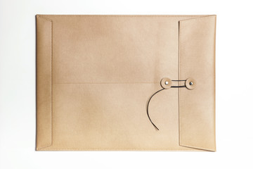 A luxury leather envelope isolated white.