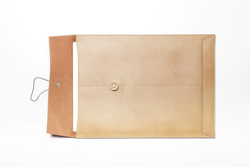 A luxury leather envelope isolated white.
