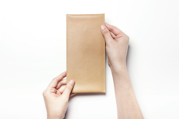 Woman hand hold a letter with leather envelope isolated white