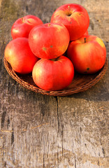 Red apples on wooden background