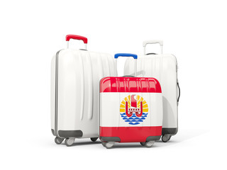 Luggage with flag of french polynesia. Three bags isolated on white
