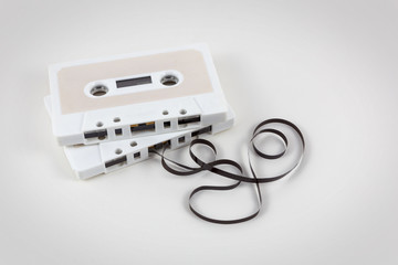 Two audio cassette tapes with pull-out tape