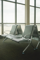 waiting area at airport terminal with empty chairs