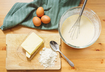 Top view of the dough and ingredients for making traditional thin pancakes.