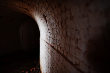 Scary brick arch tunnel on dark and some light.