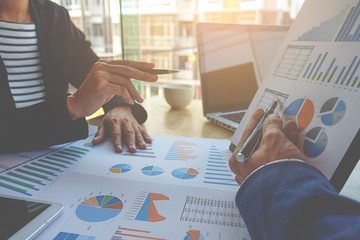 Business concept. Business people discussing the charts and graphs showing the results of their...