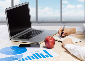 Business woman in an office holding red apple - Clipping Path