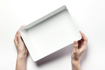 woman hand hold a white plastic empty box isolated white.
