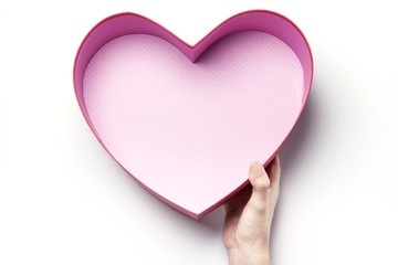 Woman hand hold a red heart gift box isolated white.