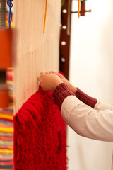 Berber woman weaving a carpet in medina souke in Marrakesh