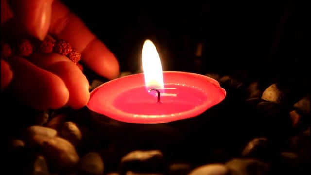    Candle andhand with mala 