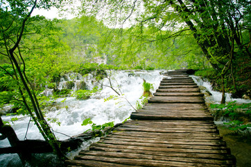 Wooden path and waterfall in Plitvice National Park, Croatia. 