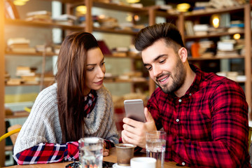 Nice friends having good time watching cool videos on internet.