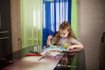 Little girl drawing at home