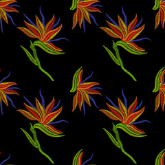 Fototapeta na wymiar Embroidery Bird of Paradise flowers, tropical Strelitzia seamless pattern. Vector fashion ornamental floral print on black background for fabric traditional folk decoration.