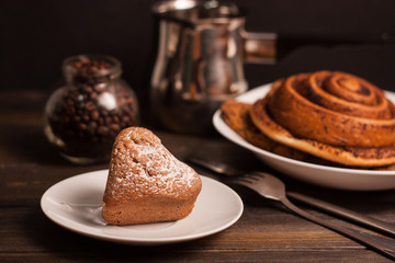 a cake on a plate and a cinnamon roll