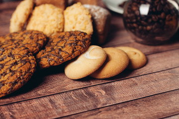 cookies on a wooden table and coffee beans in a jar