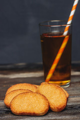drink in a glass and cookies on a table