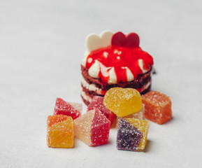 cake and marmalade cubes on a light background