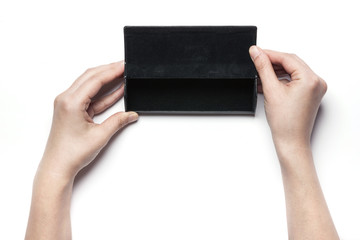 woman hand hold a black leather glasses case isolated white.
