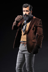 Bearded male in brown suit and gray pant with sunglasses