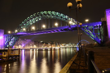 Night-time view of Tyne Bridge with the brightly lit quayside on the opposite bank, Newcastle-Upon-Tyne