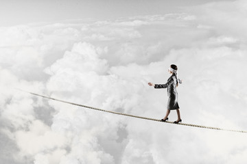 She is walking blindfolded . Mixed media