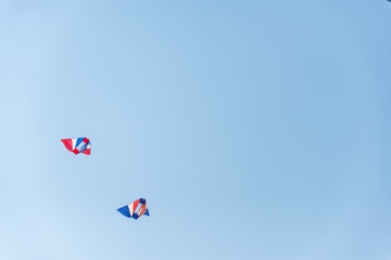 Colorful kites flying in blue sky