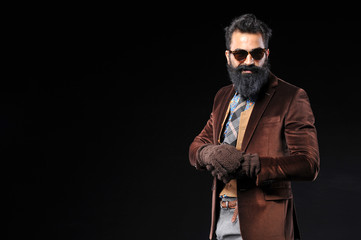 Bearded male in brown suit and gray pant with sunglasses