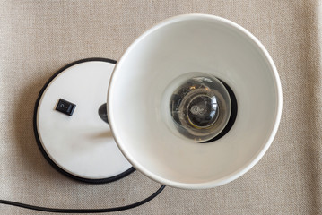 White table lamp looking up on cloth background