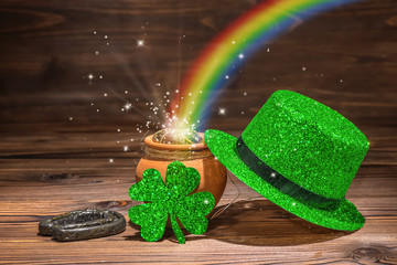 St Patricks day decoration with magic light rainbow pot full gold coins, horseshoe, green hat and...