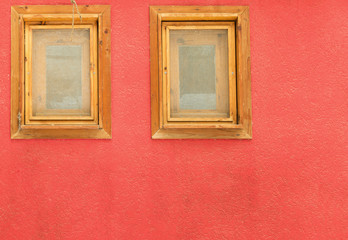 wooden windows on a red wall