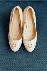 Shoes of the bride near wedding rings