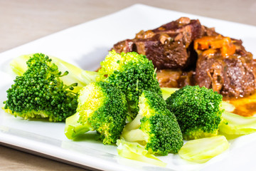 Stew with vegetables meat with broccoli is on the plate.