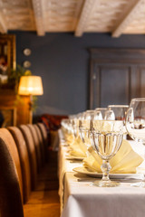 One sharp glass in a number of dishes on the table for a Banquet.