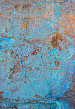 A rusty old metal plate with cracked blue gloss paint © Iuliia