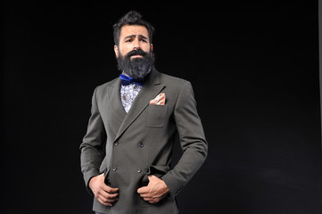 Obraz premium Bearded handsome man with suit on black background