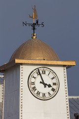 Classic clock tower with gold Britannia weather vane