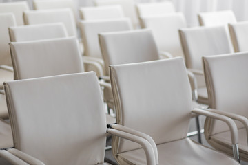 Fototapeta premium background of row of white seats. Empty hairs in the conference hall.