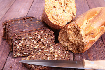 Sliced black bread on the old wooden plank