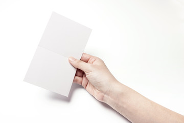 Obraz premium woman hand hold a empty post card isolated white.