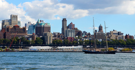 Brooklyn skyline and sailing ship on east river as seen from Wall Street, Manhattan, New York