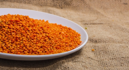 ripe fruits of red lentils on a white plate