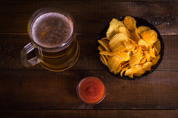 Beer and snacks on the wooden background