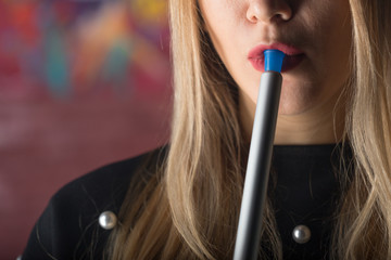 Fototapeta premium Young, beautiful girl smokes a hookah