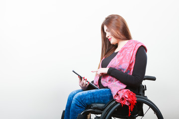 Fototapeta na wymiar Young disabled lady with tablet.